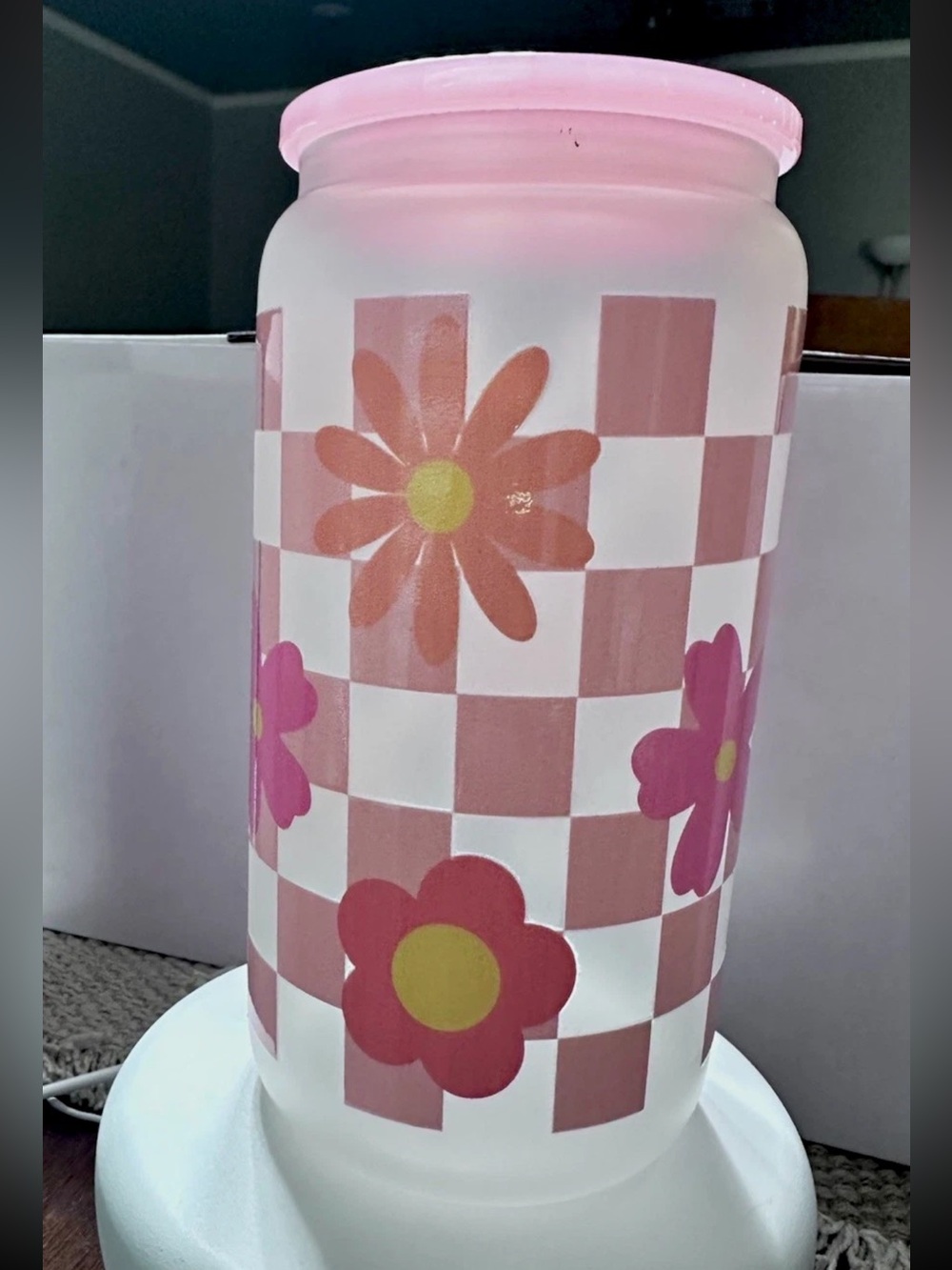 Glass tumbler with a pink plaid pattern and multicolored floral motifs. (16 oz)